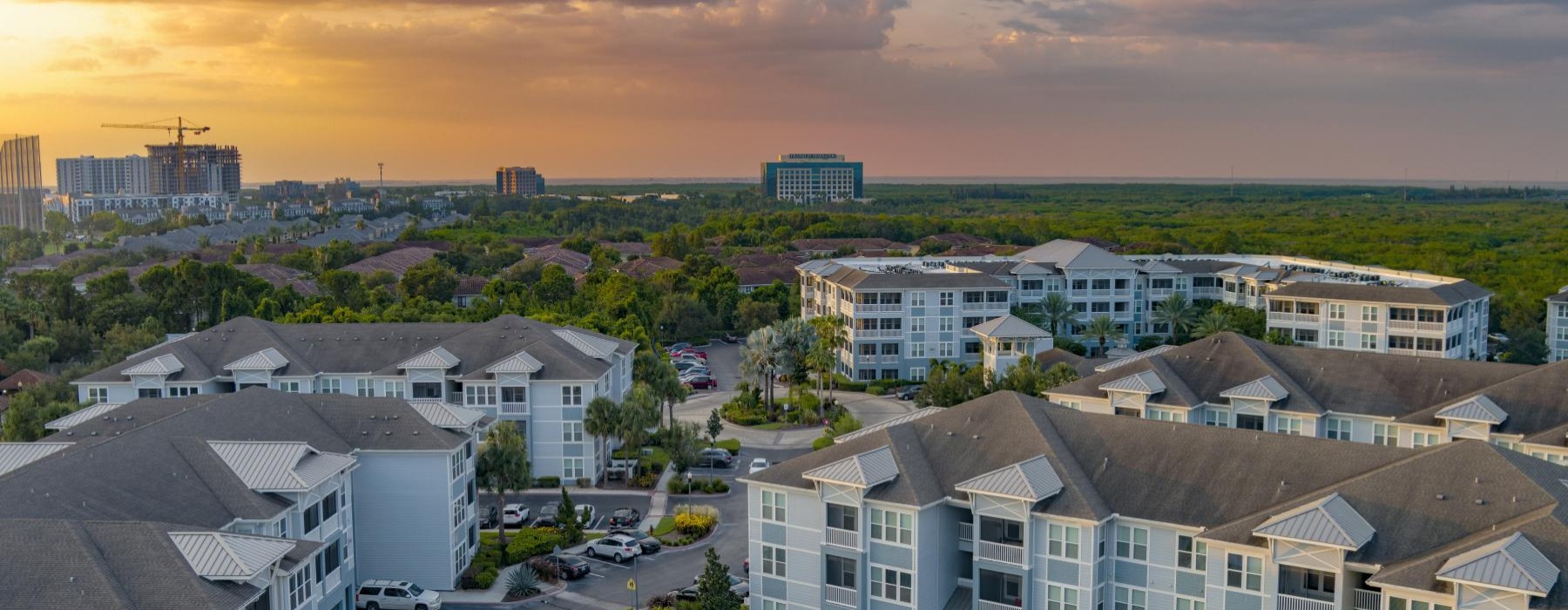 a group of buildings with cars parked in the front