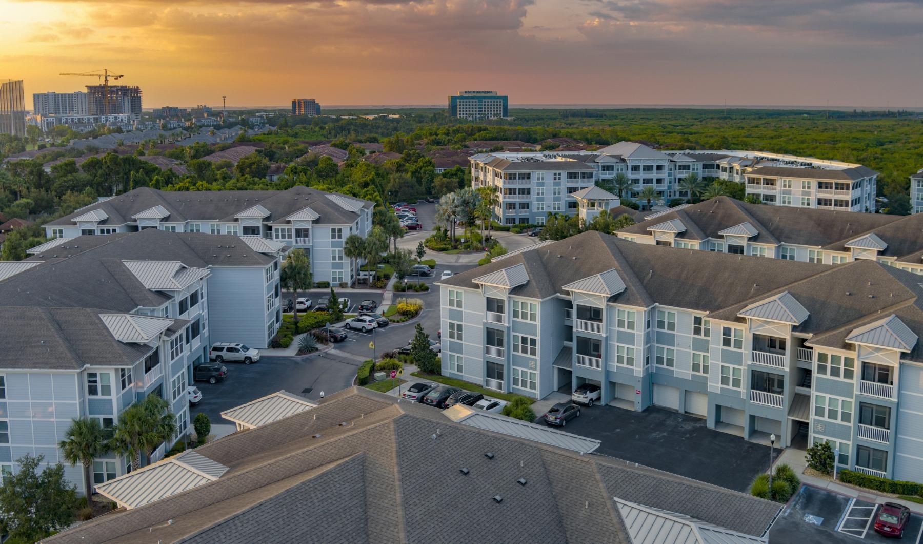 a group of buildings with cars parked in the front
